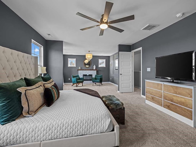 bedroom featuring a ceiling fan, visible vents, baseboards, and carpet flooring