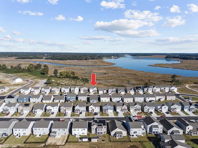 drone / aerial view with a residential view and a water view