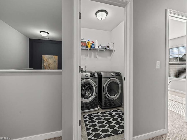 laundry area with carpet floors, laundry area, baseboards, and washing machine and clothes dryer