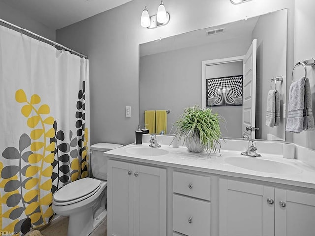 full bathroom featuring visible vents, a sink, toilet, and double vanity