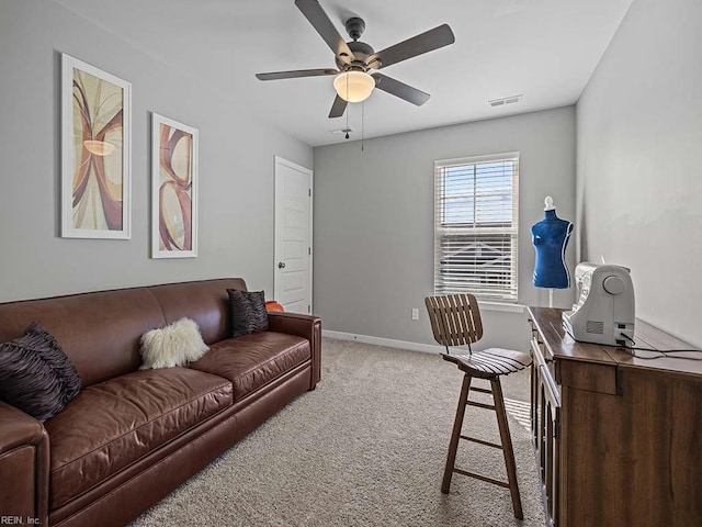 carpeted living room with baseboards, visible vents, and a ceiling fan