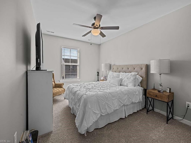 carpeted bedroom featuring ceiling fan, visible vents, and baseboards