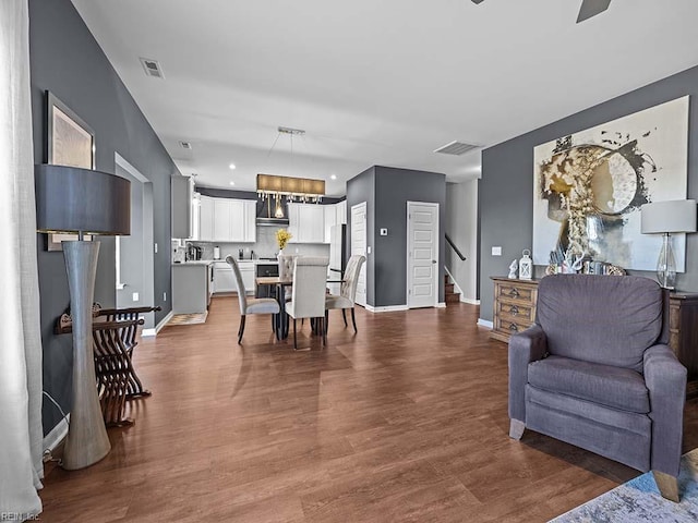 interior space with visible vents, stairs, baseboards, and dark wood finished floors