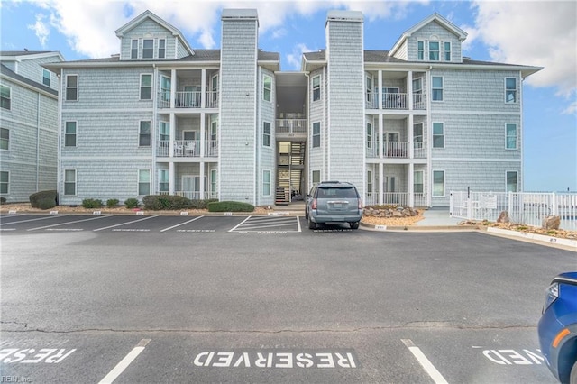 view of building exterior with uncovered parking