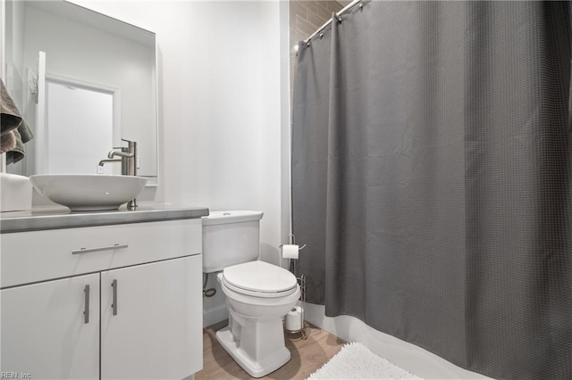 bathroom featuring vanity, toilet, and wood finished floors