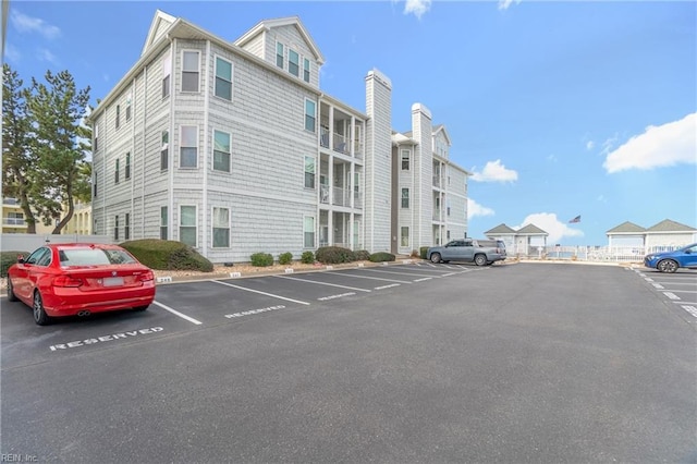 view of building exterior featuring uncovered parking