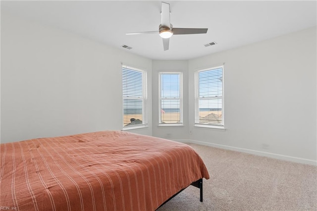 bedroom with baseboards, visible vents, ceiling fan, and carpet flooring