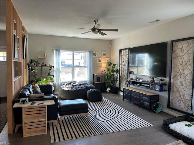 living area with ceiling fan, dark wood-style flooring, visible vents, and baseboards