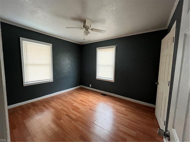 unfurnished bedroom with light wood finished floors, baseboards, and ornamental molding