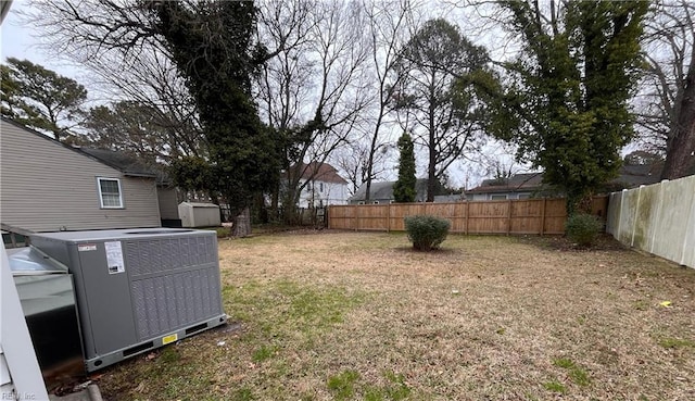 view of yard featuring central air condition unit and a fenced backyard