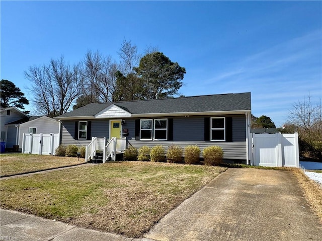 ranch-style house with a gate, fence, and a front lawn