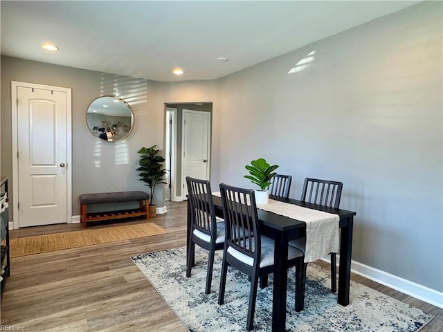 dining area with recessed lighting, baseboards, and wood finished floors