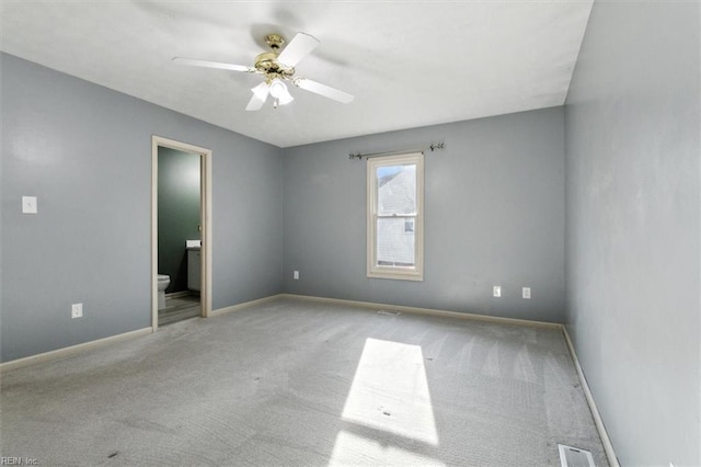 unfurnished room with baseboards, light colored carpet, visible vents, and a ceiling fan