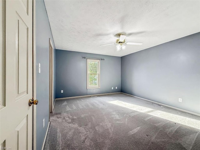 spare room with visible vents, baseboards, ceiling fan, carpet, and a textured ceiling