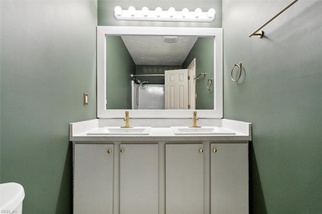 bathroom featuring a sink, toilet, and double vanity