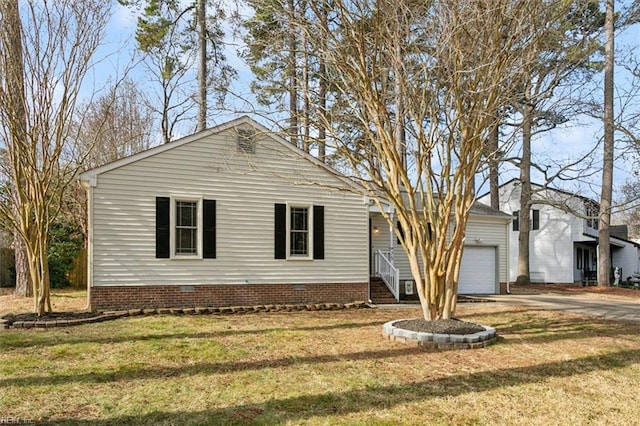 view of front of house with a front yard, crawl space, driveway, and an attached garage