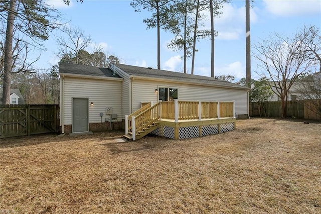 back of house featuring a fenced backyard and a wooden deck