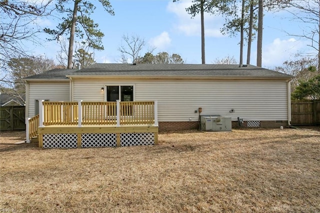 rear view of property with crawl space, fence, a deck, and a yard