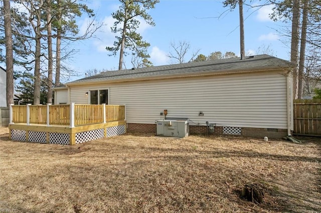 back of house featuring crawl space, a yard, a deck, and fence