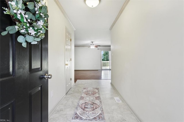 interior space featuring crown molding, baseboards, and ceiling fan