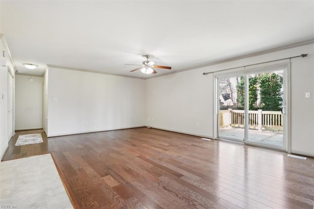 spare room featuring a ceiling fan, ornamental molding, and wood finished floors