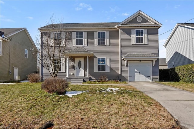 view of front of home with a garage, driveway, and a front yard