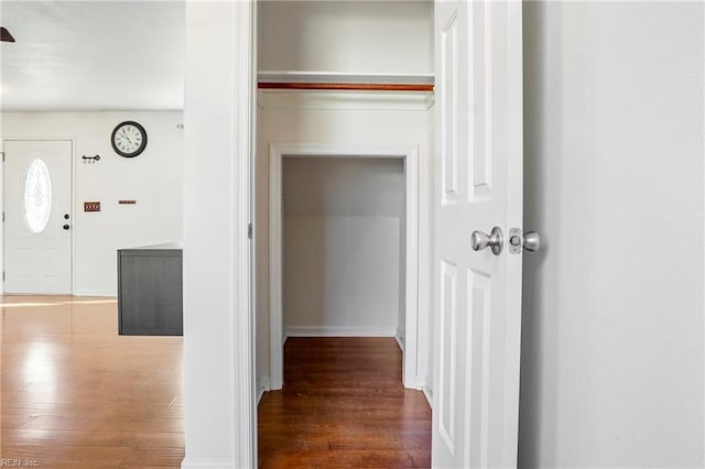 hallway with dark wood-type flooring