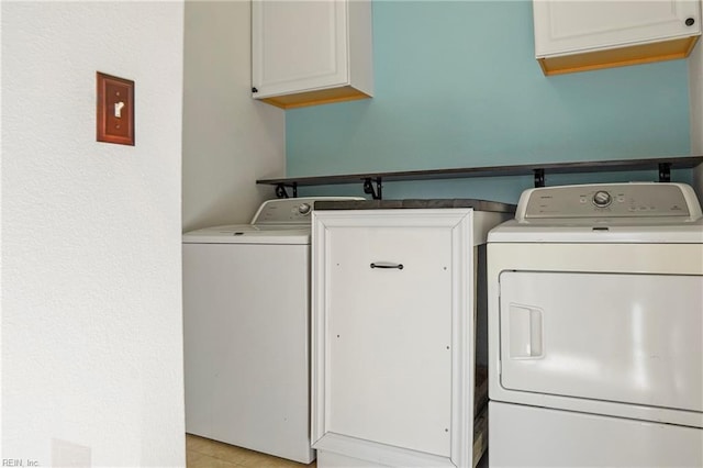 washroom featuring cabinet space and separate washer and dryer