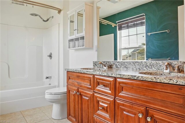 bathroom featuring double vanity, shower / bath combination, toilet, tile patterned floors, and a sink