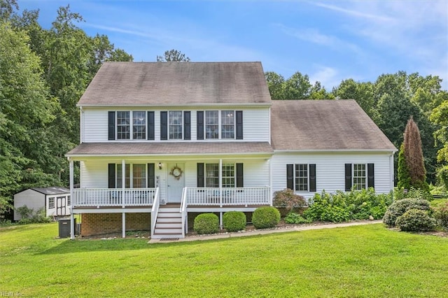 view of front of house featuring a porch, a front lawn, central AC unit, and a shingled roof