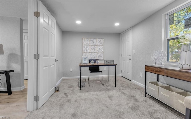 office area with light carpet, a textured wall, recessed lighting, and baseboards