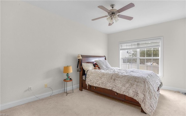 bedroom with light carpet, ceiling fan, and baseboards