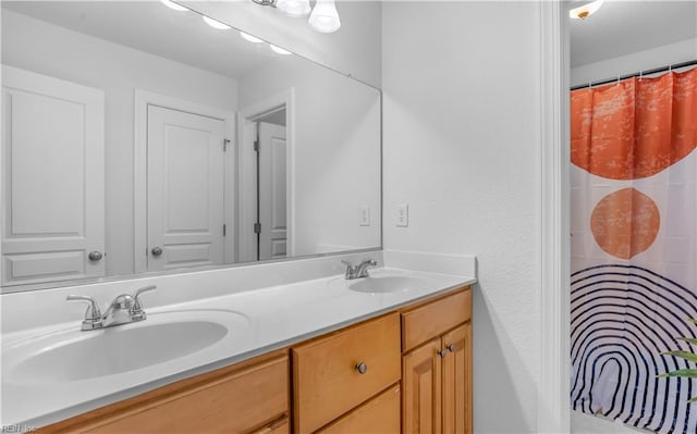 full bathroom featuring a sink and double vanity