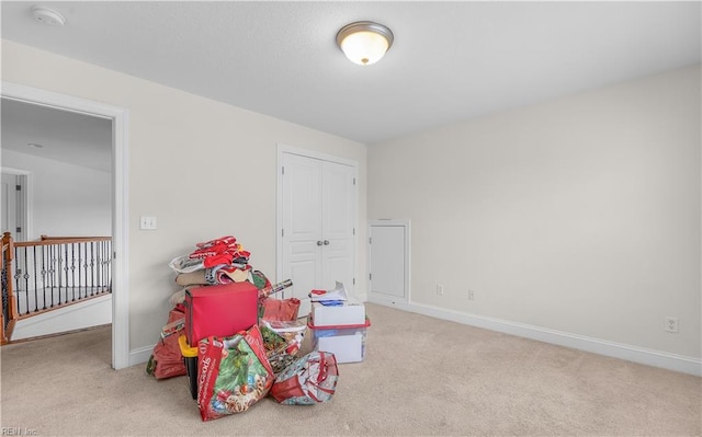 playroom with light carpet and baseboards