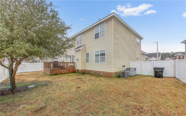 back of property with crawl space, a fenced backyard, a yard, and a wooden deck