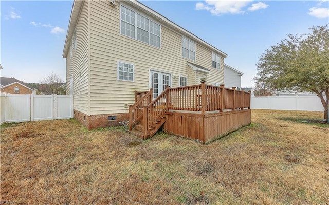 back of house featuring crawl space, a fenced backyard, a deck, and a yard