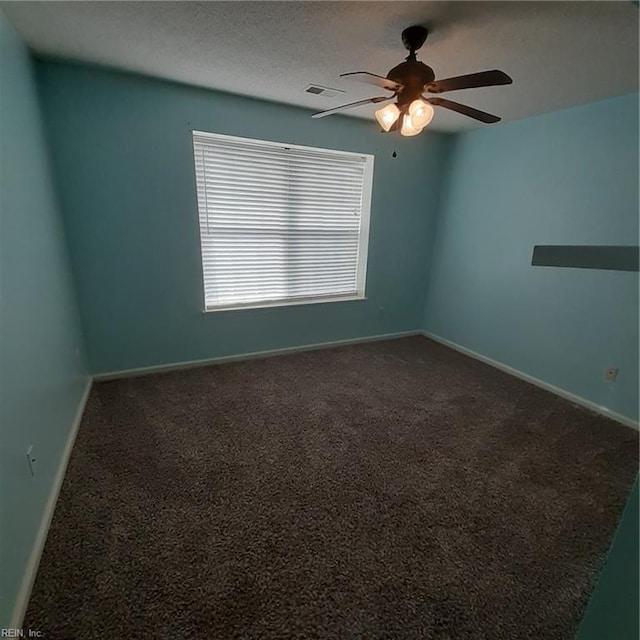 carpeted empty room with visible vents, ceiling fan, a textured ceiling, and baseboards