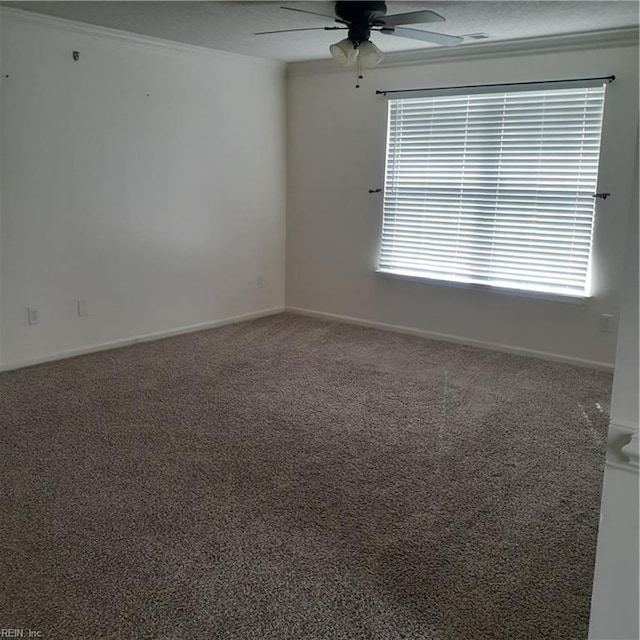 spare room featuring crown molding, carpet flooring, ceiling fan, and baseboards