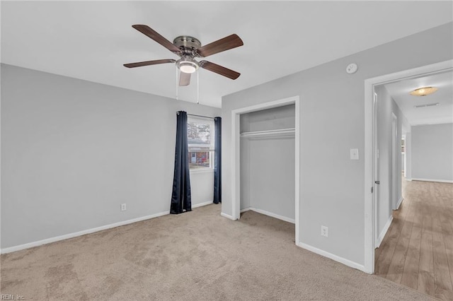 unfurnished bedroom with a ceiling fan, a closet, carpet floors, and baseboards