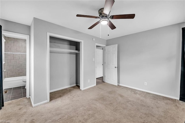 unfurnished bedroom featuring connected bathroom, a ceiling fan, baseboards, a closet, and carpet