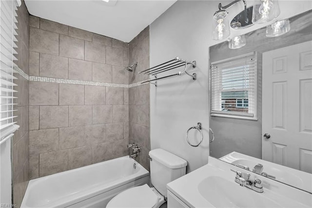 full bath with toilet, vanity, and bathing tub / shower combination