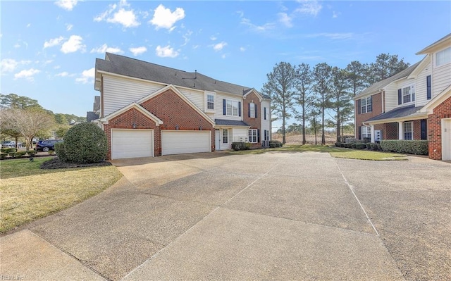 view of front facade featuring a front yard, concrete driveway, brick siding, and an attached garage