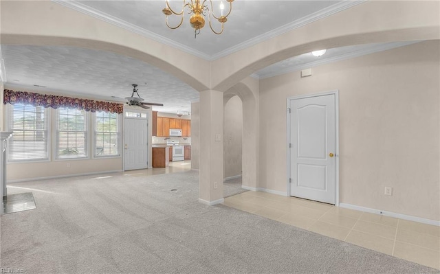 unfurnished living room with arched walkways, light colored carpet, crown molding, and ceiling fan with notable chandelier