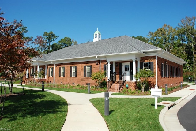 view of front of property with crawl space, brick siding, a front lawn, and roof with shingles