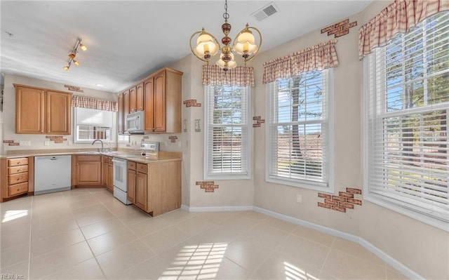 kitchen with light countertops, visible vents, light tile patterned flooring, white appliances, and baseboards