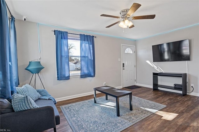 living room with ceiling fan, dark wood-style flooring, and baseboards