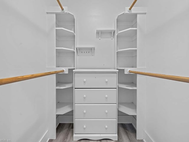 spacious closet with dark wood finished floors