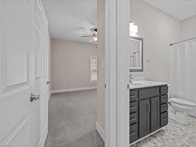 full bath with baseboards, toilet, ceiling fan, curtained shower, and vanity