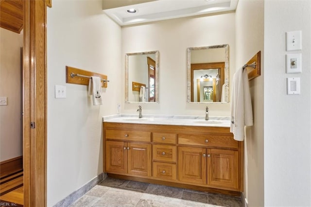 9954 Bonniville Rd, Hayes, VA 23072 - bathroom featuring double vanity, baseboards, and a sink
