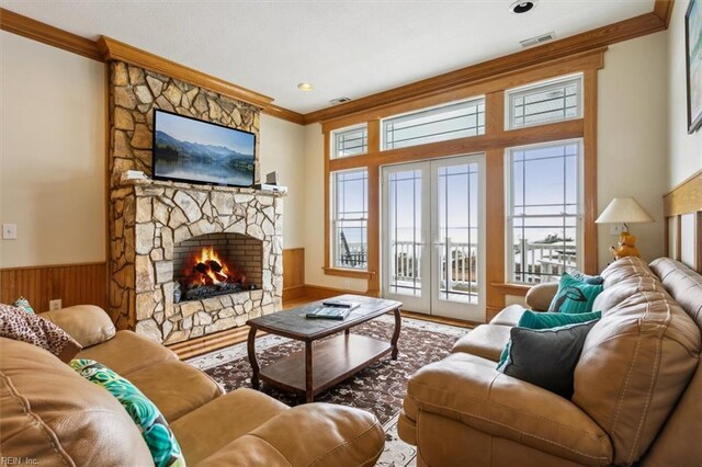 9954 Bonniville Rd, Hayes, VA 23072 - living room with a stone fireplace, ornamental molding, a wealth of natural light, and french doors